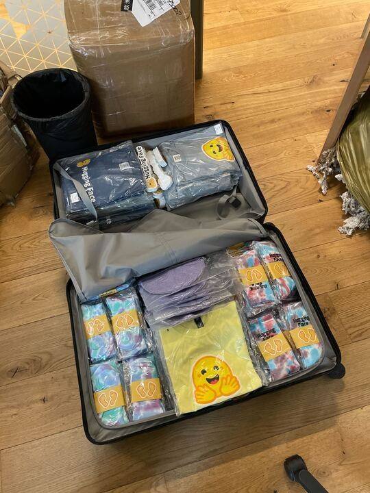 Hugging Face PyTorch Conf suitcase full of 🤗 swag